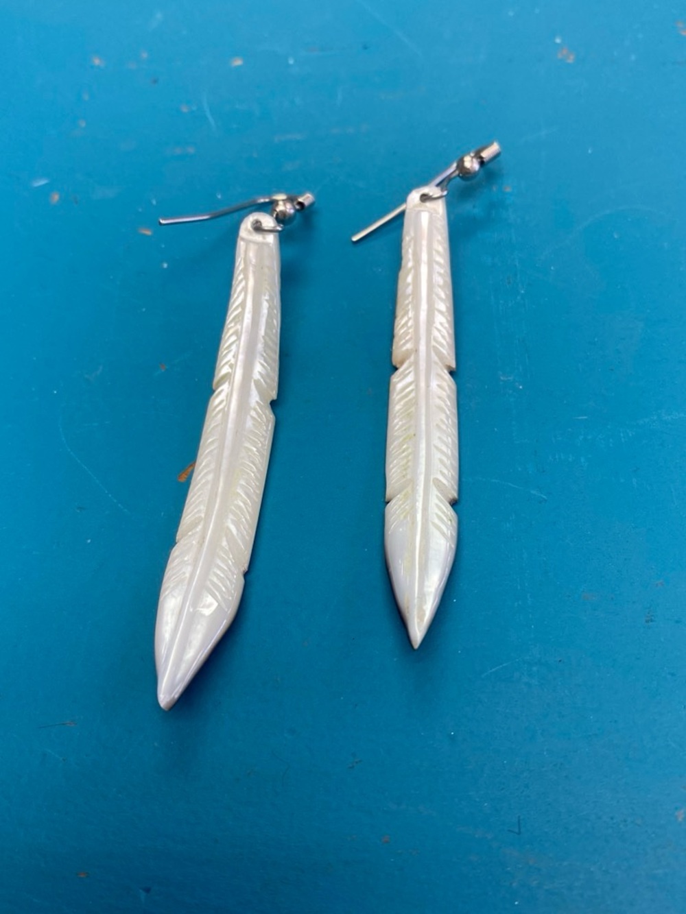 Hand carved drop shell earring.
